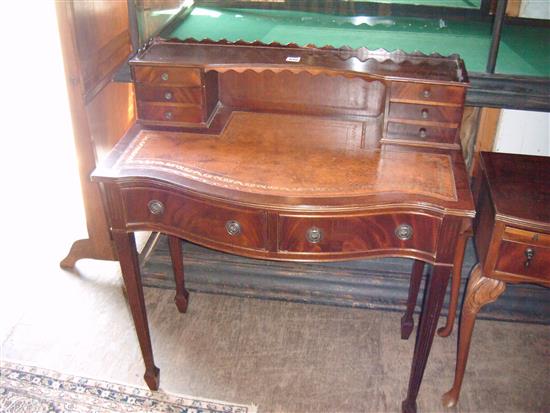 Mahogany serpentine fronted writing table